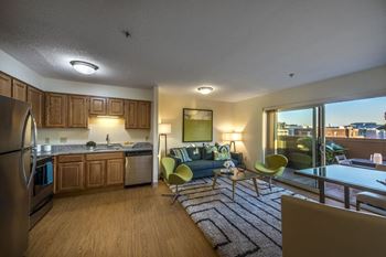 A living room with a kitchen and a couch